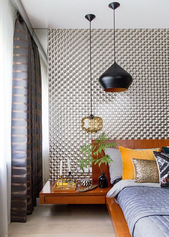 a mid-century modern bedroom with a duo of statement pendant lamps - in black and in amber glass