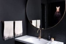 13 an onyx powder room with a contrasting white sink, white towels and shiny black penny tiles