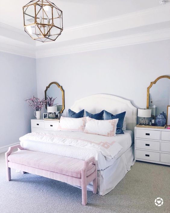 a girlish bedroom with brass framed mirrors and a matching geometric chandelier for a shiny touch