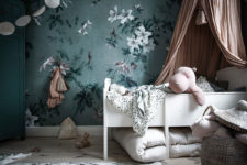 16 a refined nursery with a green floral accent wall and touches of dark green and soft blush and pink for a chic look