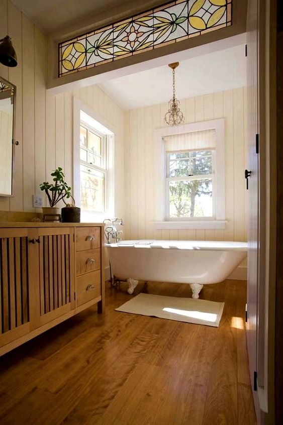 a farmhouse bathroom with a white vintage clawfoot tub that sets the tone in the space