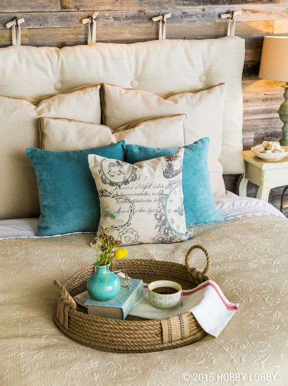 a cozy rustic bedroom with a neutral hanging cushion headboard with tufting for a bold touch