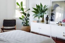 19 a boho bedroom with two statement plants that catch an eye and refresh the space