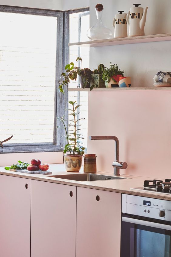 a soft shade of pink adds warmth and coziness to this small kitchen, neutrals make the space bolder