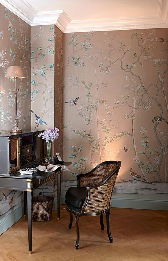 a very refined moody space with floral and fauna wallpaper, elegant vintage furniture and some lights