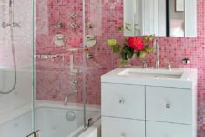 20 a small yet contrasting bathroom done in pink and white, with a statement wall and matching towels