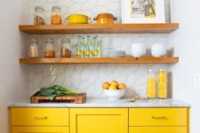 21 a tiny kitchen with bright yellow cabinets, all whites and wooden shelves over the cabinets