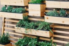 22 a planter wall with wooden fixtures and beams attached to one single wood slab screen is a creative idea