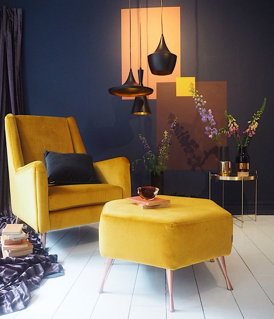 a small contrasting space done in navy and white and made bolder with yellow furniture for a bright look