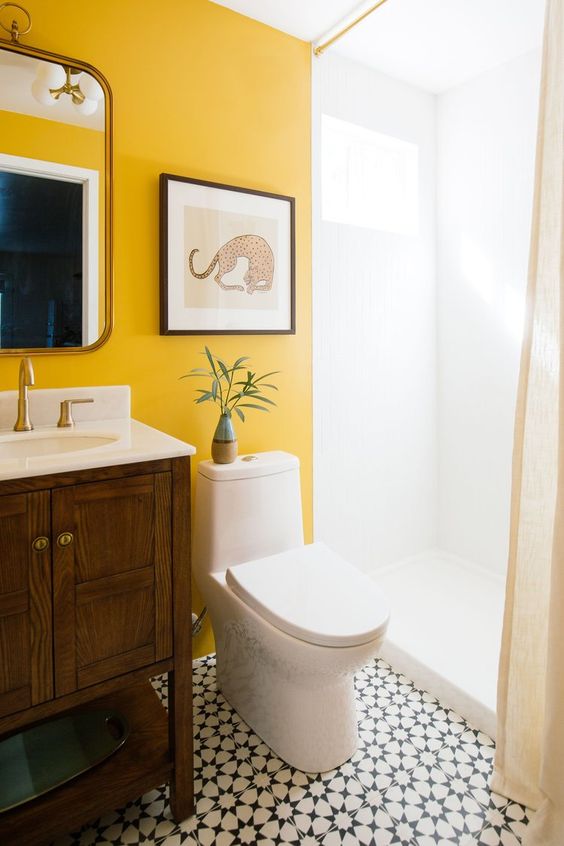 make your monochromatic bathroom unique and bold with a statement marigold wall