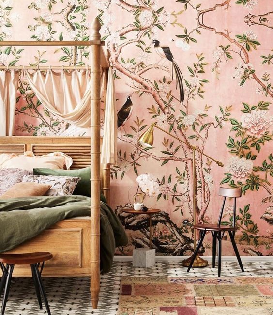 pink flora and fauna wallpaper creates a warm ambience in the bedroom and takes over the whole space