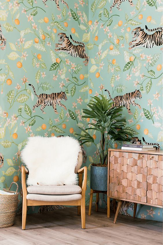 a whimsical space with unique floral and fauna wallpaper that gives a bold tropical feel to the space