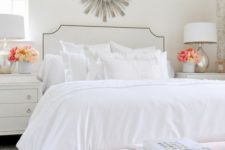 26 a chic and airy bedroom with a white bed and an arrangement of white pillows but of various fabrics