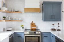 a blue and white farmhouse kitchen with wooden beams and open shelves plus a white square tile backsplash