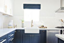 a bold kitchen with navy lower cabinets, white upper ones, gold touches, a bold boho rug and navy shades
