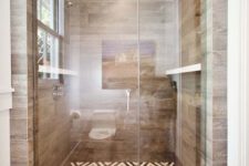 a bold shower space with a mosaic tile floor and wood look tiles on the walls for a warm feel and look here