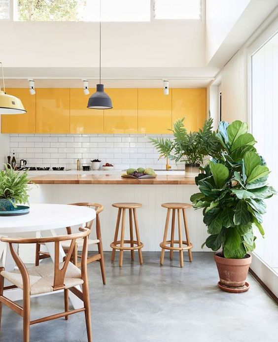 a bright tropical kitchen done with yellow upper cabinets and all white everything plus a skylight for a refresh