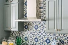 a lovely kitchen with a mosaic backsplash
