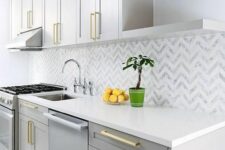 a lovely kitchen with a chevron tile backsplash