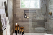 a contemporary bathroom done with mosaic and wood look tiles in the shower to highlight this zone