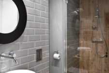 a contemporary bathroom with grey tiles and wood look ones in the shower space and on the floor for a warm feel