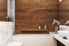 a contemporary bathroom with warm colored wood look tiles and white appliances for a fresh and bold look