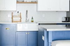 a contemporary kitchen with light blue lower cabinets and white upper ones plus touches of gold
