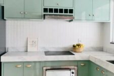 a glossy mint blue kitchen with flat panel cabinets, white stone countertops and a white embossed tile backsplash