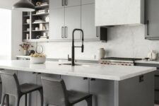 a grey farmhouse kitchen with white countertops, a white marble backsplash, black pendant lamps and black stools