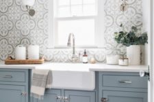 a light blue kitchen with a grey mosaic tile backsplash and metallic handles is a beautiful idea with a traditional feel