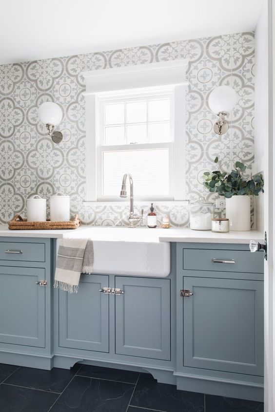 a light blue kitchen with a grey mosaic tile backsplash and metallic handles is a beautiful idea with a traditional feel
