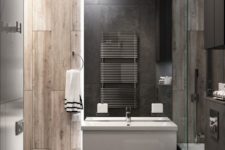a minimalist bathroom with wood look tiles of two different shades and stone like tiles on the floor