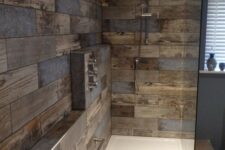 a modern bathroom clad with reclaimed wood look tiles, with white appliances and built-in lights is a stylish and cool idea