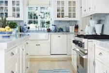 a neutral traditional kitchen with blue countertops and a backsplash, rugs and lamps for a touch of color