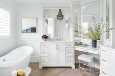 a refined bathroom with a wood look tile floor, a chic vanity, a tub, a beaded pendant lamp, a floating makeup vanity and a stool