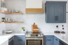 a slate blue kitchen with a white tile backsplash and countertops plus touches of wood for warmth