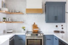 a slate blue kitchen with a white tile backsplash and countertops plus touches of wood for warmth