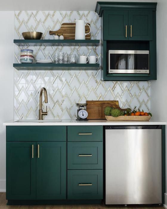 a stylish kitchen with hunter green cabinets, a zig-zag tile backplash and touches of gold for a chic look (designed by Kimberlee Gorsline)