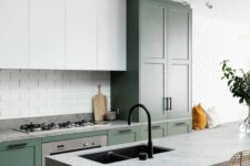 a stylish modern kitchen with green and white cabinets, a white brick backsplash and grey stone countertops is ultimate