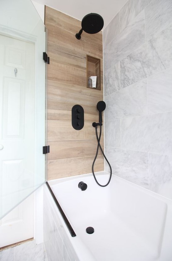 Marble can be paired with wood like tiles to create a chic and luxurious space, add black fixtures for a modern feel