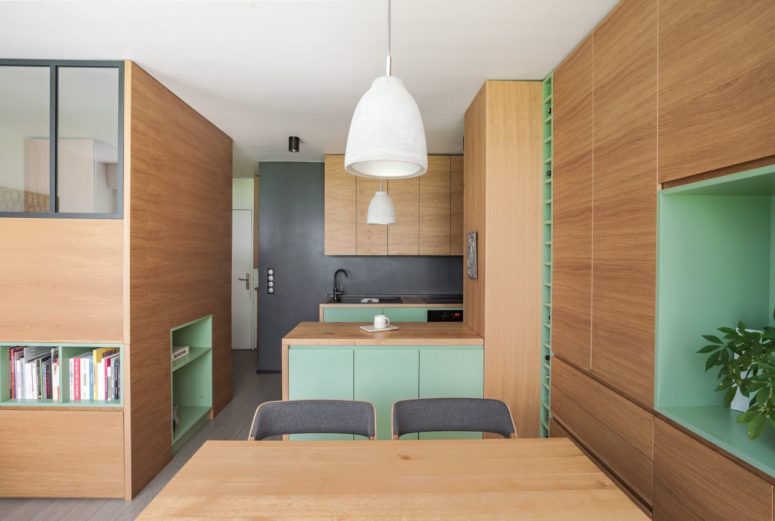 The whole apartment is done in light-colored oak, with touches of bright green
