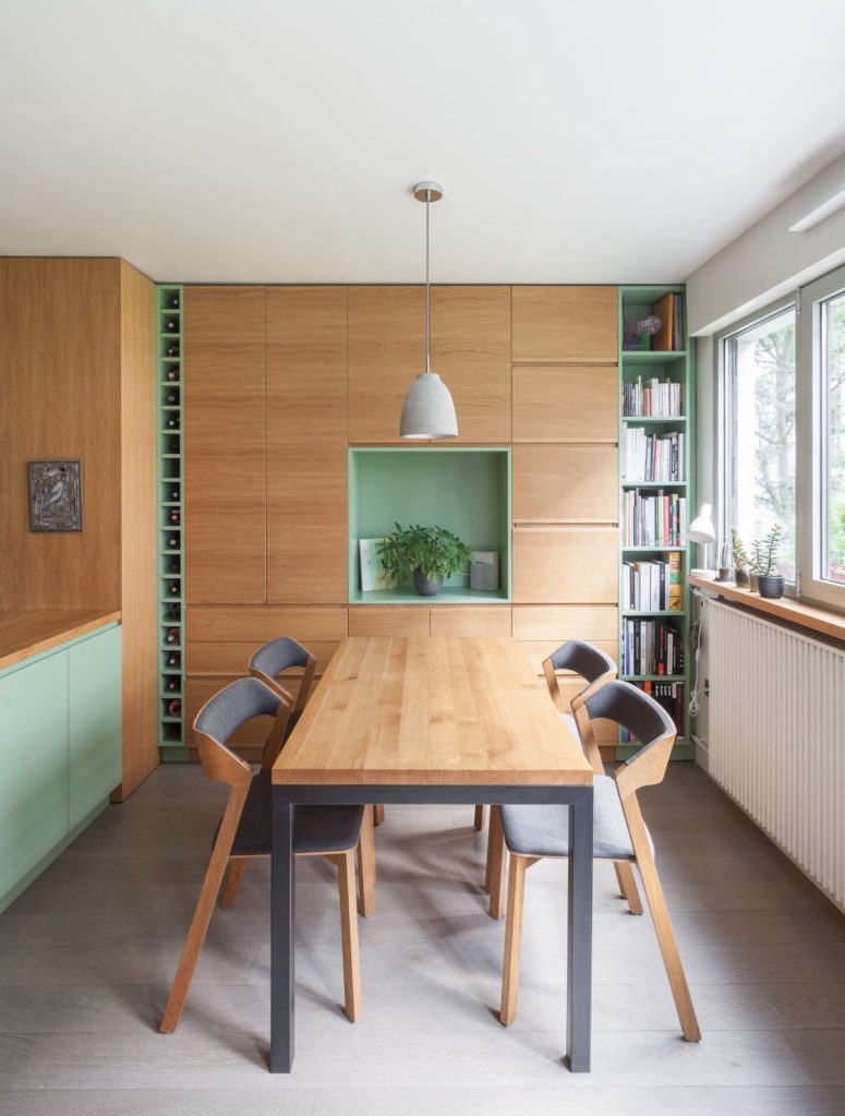 The dining zone is done with a contemporary set, with a built-in storage unit and shelves