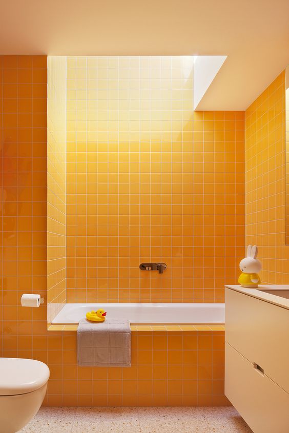 a bright bathroom done in sunny yellow, with touches of white and a skylight to create a mood