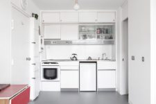 06 The kitchen is very compact and white, which helps to give it a bright and airy look