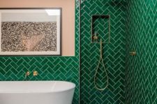 07 bright emerald tiles clad in a herringbone pattern, with a pink wall and touches of gold