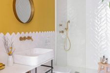 08 a colorful bathroom with mustard walls, a mosaic floor, mustard textiles and brass fixtures to raise your mood