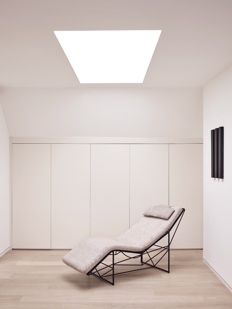 I love this minimalist nook that features much storage space and a skylight with a lounger   so cool to read here