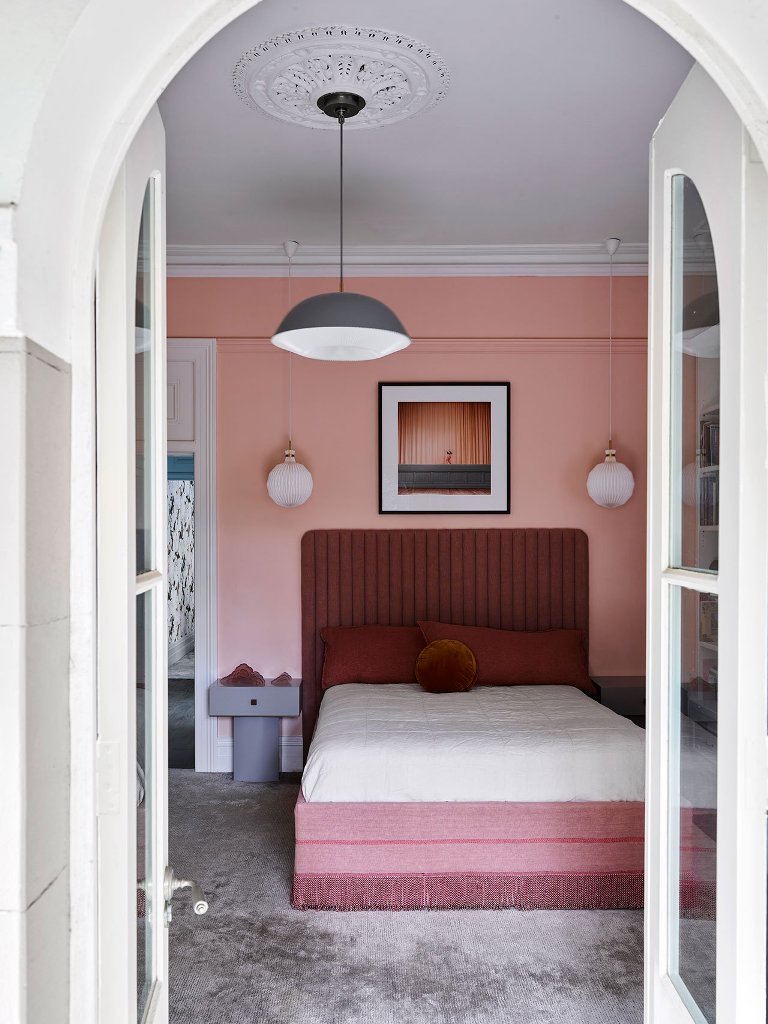 One more bedroom is filled with pink and burgundy and accented with mid century modern touches