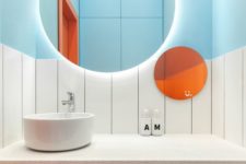 10 a bold bathroom with light blue half walls, an orange shelf and an orange round mirror for a bright look