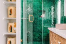 15 a bright eclectic bathroom design with pink geometric floor and green tile shower, with boho rug and fun tassel baskets